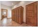 Hallway with large built-in cabinets and stone tile flooring leading to another room at 2780 El Camino Rd, Las Vegas, NV 89146
