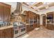 Gourmet kitchen with stainless steel appliances, custom cabinets, and granite countertops with mosaic backsplash at 2780 El Camino Rd, Las Vegas, NV 89146