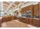 Gourmet kitchen with stainless steel appliances, custom cabinetry, and granite countertops with mosaic backsplash at 2780 El Camino Rd, Las Vegas, NV 89146
