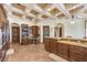 Spacious kitchen with wooden cabinets, granite countertops, and custom island with coffered ceilings and recessed lights at 2780 El Camino Rd, Las Vegas, NV 89146