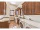 Spacious laundry room with a sink, granite countertops, and modern washer and dryer units at 2780 El Camino Rd, Las Vegas, NV 89146