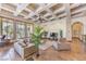 Sophisticated living room featuring a coffered ceiling, modern furniture, and bright windows at 2780 El Camino Rd, Las Vegas, NV 89146
