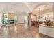 Open-concept living space featuring travertine floors, a fireplace, and seamless access to the dining area at 2780 El Camino Rd, Las Vegas, NV 89146