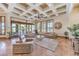 Inviting living room with a coffered ceiling, modern furniture, and seamless access to the outdoor area at 2780 El Camino Rd, Las Vegas, NV 89146