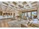Open living space with a bar, dining area, modern furniture, and access to the patio via sliding doors at 2780 El Camino Rd, Las Vegas, NV 89146