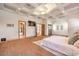 Spacious main bedroom features a coffered ceiling, tv, and doorway to the bathroom at 2780 El Camino Rd, Las Vegas, NV 89146
