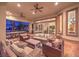 Spacious covered patio with comfortable seating, ceiling fans, and views of the lush backyard and outdoor games at 2780 El Camino Rd, Las Vegas, NV 89146