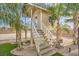 Charming elevated playhouse with stairs and surrounded by tropical palm trees on a desert landscape at 2780 El Camino Rd, Las Vegas, NV 89146