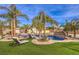 Backyard oasis with a custom pool, lush landscaping, and lounge chairs for relaxation at 2780 El Camino Rd, Las Vegas, NV 89146