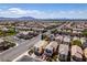 An elevated view of the neighborhood showcasing various homes with desert landscaping and mountain views at 2929 Salado Creek Ave, North Las Vegas, NV 89081