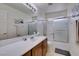 Bright bathroom featuring a tub-shower combo and a large vanity with ample counter space at 2929 Salado Creek Ave, North Las Vegas, NV 89081