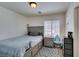 Comfortable bedroom with a gray bed, soft rug, and natural light at 2929 Salado Creek Ave, North Las Vegas, NV 89081
