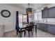 Cozy dining area with a dark wood table, overhead lighting, and views of the backyard at 2929 Salado Creek Ave, North Las Vegas, NV 89081