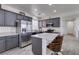 Well-equipped kitchen with gray cabinets, stainless steel appliances, and a convenient center island with bar stools at 2929 Salado Creek Ave, North Las Vegas, NV 89081