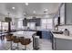 Modern kitchen featuring gray cabinets, stainless steel appliances, and a center island with bar seating at 2929 Salado Creek Ave, North Las Vegas, NV 89081