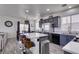 Modern kitchen with gray cabinets, stainless steel appliances, and a center island with bar seating adjacent dining area at 2929 Salado Creek Ave, North Las Vegas, NV 89081