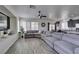 Spacious living room with large windows, recessed lighting, and a comfortable sectional sofa at 2929 Salado Creek Ave, North Las Vegas, NV 89081