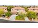 Aerial view of a two-story home with a well-manicured lawn, mature trees, and a three-car garage at 366 Rancho La Costa St, Las Vegas, NV 89138