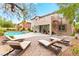 Expansive backyard featuring a pool, spa, patio, spiral staircase, and multiple lounge chairs at 366 Rancho La Costa St, Las Vegas, NV 89138