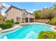 Spacious backyard with a pool, spa, covered patio, spiral staircase, and beautifully landscaped areas at 366 Rancho La Costa St, Las Vegas, NV 89138