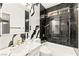 Modern bathroom featuring black and white marble tile, gold fixtures, and shower-tub combination at 366 Rancho La Costa St, Las Vegas, NV 89138
