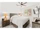 Bright bedroom featuring a ceiling fan, modern TV, and stylish gray-toned flooring and wooden furniture at 366 Rancho La Costa St, Las Vegas, NV 89138