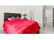 Cozy bedroom with red accents on the bed, tile floors and an open ensuite bathroom with modern fixtures at 366 Rancho La Costa St, Las Vegas, NV 89138
