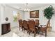 Elegant dining room features a chandelier, large window, and seating for eight at 366 Rancho La Costa St, Las Vegas, NV 89138