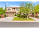 Charming two-story home featuring a terracotta tile roof, arched windows, and a well-manicured lawn at 366 Rancho La Costa St, Las Vegas, NV 89138
