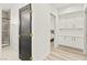 Hallway featuring modern cabinets, wood floors, and a view into a bedroom and bathroom at 366 Rancho La Costa St, Las Vegas, NV 89138