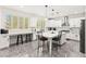 Modern kitchen with white cabinets, stainless steel appliances, and an island with seating at 366 Rancho La Costa St, Las Vegas, NV 89138
