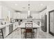 Eat-in kitchen with white cabinets, stainless steel appliances, a pantry door, and a large central island at 366 Rancho La Costa St, Las Vegas, NV 89138