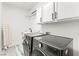 Modern laundry room features updated washer, dryer, cabinets and sink at 366 Rancho La Costa St, Las Vegas, NV 89138