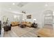 Cozy living room with wood floors, ceiling fan, and tan leather sofas at 366 Rancho La Costa St, Las Vegas, NV 89138