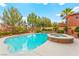 Sparkling swimming pool and hot tub surrounded by a well-maintained yard and lush greenery at 366 Rancho La Costa St, Las Vegas, NV 89138