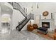 Elegant staircase featuring black wrought iron railing, a fireplace and soaring ceilings creating a grand entrance at 366 Rancho La Costa St, Las Vegas, NV 89138