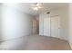 Carpeted bedroom with a ceiling fan and a closet at 3975 N Hualapai Way # 212, Las Vegas, NV 89129