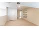 A bedroom with light-colored carpet and a door that leads to a bathroom at 3975 N Hualapai Way # 212, Las Vegas, NV 89129