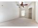 Spacious carpeted bedroom featuring a ceiling fan, natural light, and a nook for storage at 3975 N Hualapai Way # 212, Las Vegas, NV 89129