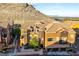 Stylish townhome featuring a 2-car garage, turret, desert landscaping, and mountain views at 3975 N Hualapai Way # 212, Las Vegas, NV 89129