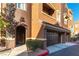Townhome exterior showcasing attached two-car garage and covered entry at 3975 N Hualapai Way # 212, Las Vegas, NV 89129