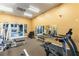 Community gym with mirrored wall, cardio equipment and free weights at 3975 N Hualapai Way # 212, Las Vegas, NV 89129