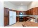 Well-lit kitchen features wood cabinets, tile flooring, and modern appliances at 3975 N Hualapai Way # 212, Las Vegas, NV 89129