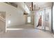 Open living room with high ceilings, fan, sliding glass door, and stairs at 3975 N Hualapai Way # 212, Las Vegas, NV 89129