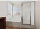 Bathroom with a soaking tub next to the two windows and glass-enclosed shower at 4217 Box Canyon Falls Ave, North Las Vegas, NV 89085