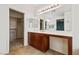 Bathroom vanity with double sinks, a large mirror, and a walk-in closet at 4217 Box Canyon Falls Ave, North Las Vegas, NV 89085