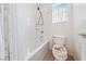 Bright bathroom with a shower-tub combo, toilet with decorated lid, and window offering a clean and functional space at 4217 Box Canyon Falls Ave, North Las Vegas, NV 89085