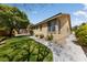 A single-story home is nicely landscaped with a concrete walkway and freshly mowed grass at 4217 Box Canyon Falls Ave, North Las Vegas, NV 89085