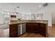 Kitchen sink area with granite countertops, wood cabinets, and stainless steel dishwasher at 4217 Box Canyon Falls Ave, North Las Vegas, NV 89085