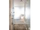 Modern bathroom featuring a luxurious soaking tub and a sleek, glass-enclosed shower with marble surround at 4381 W Flamingo Rd # 1504, Las Vegas, NV 89103